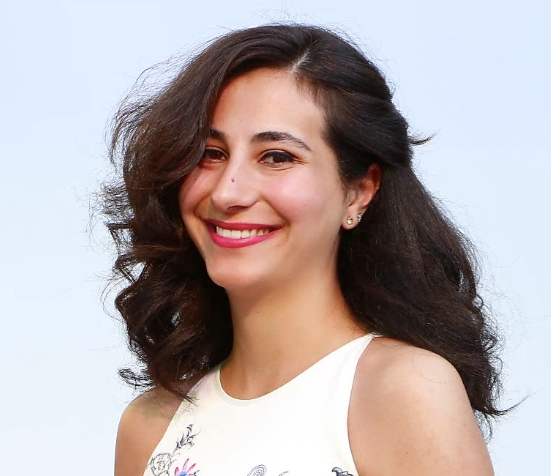 A photo of Mona Khneisser smiling at the camera.