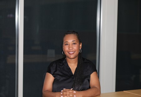 A photo of Carileigh Jones with her hands folded, smiling at the camera.