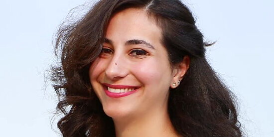 A photo of Mona Khneisser smiling at the camera.