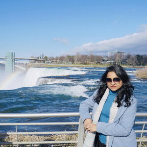 Israt Jahan poses in front of a waterfall