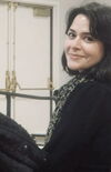 A photo of Mahbubeh Moquadam smiling at the camera.