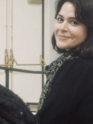 A photo of Mahbubeh Moquadam smiling at the camera.
