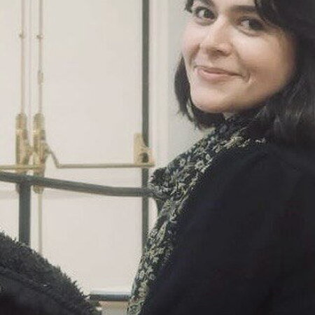 A photo of Mahbubeh Moquadam smiling at the camera.